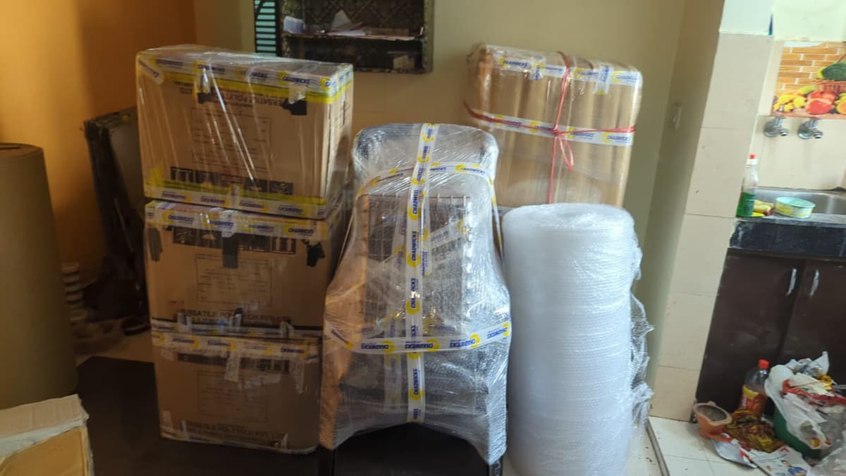 Office furniture and cartons wrapped for a commercial move