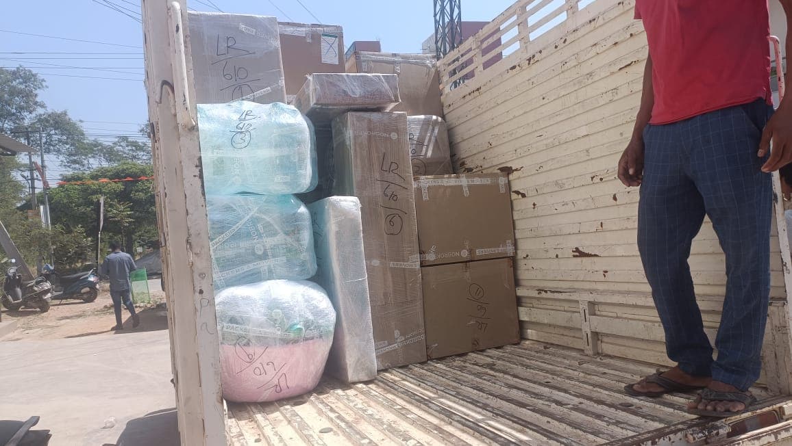 Household shifting in progress with a Triveni Packers and Movers vehicle