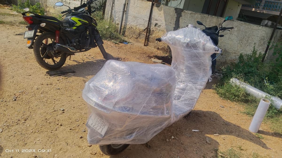 Two-wheeler wrapped in protective film before transport by Triveni Packers and Movers